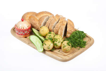 Potatoes, greenery and tableware on isolated satudio backgroundの写真素材