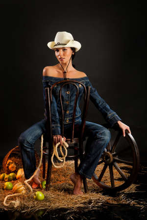 Young beautiful woman dressed in western styleの写真素材