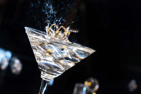 Two engagement rings in the glass on a studio backgroundの写真素材