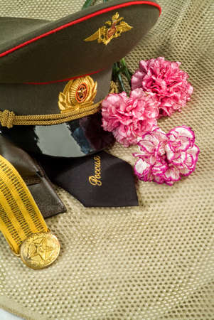 Flowers and army equipment on a studio backgroundの写真素材