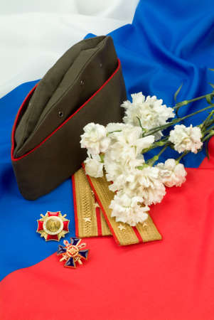 Flowers and army equipment on a studio backgroundの写真素材