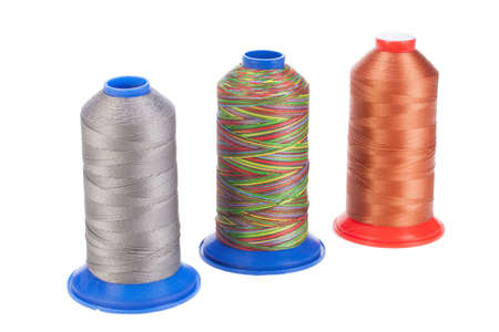 Bobbins with silk thread on an isolated studio background
