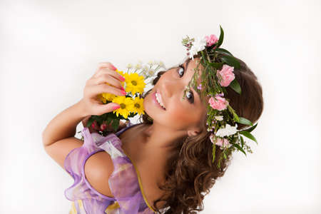 Young woman with flowers on isolated backgroundの写真素材