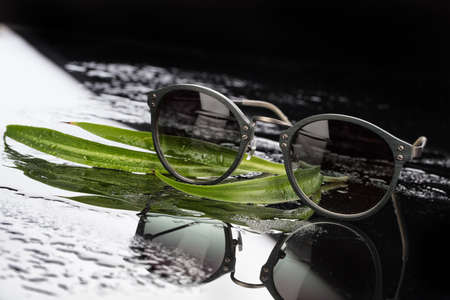 Sunglasses on a studio glass backgroundの写真素材