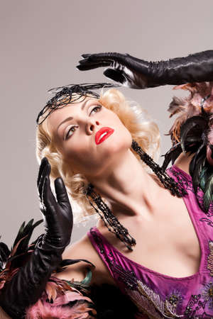 Young blonde woman in fashionable clothing in retro style on isolated background