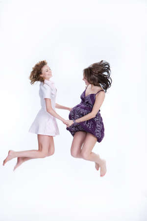 Young woman jumping and laughingの写真素材