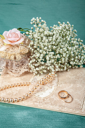 Two wedding rings and flowers on a fabric backgroundの写真素材