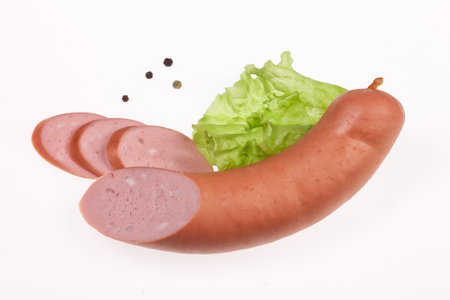 Isolated sausage with greenery on a white studio backgroundの写真素材
