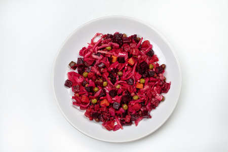 Plate with red- beet salad on an isolated studio backround