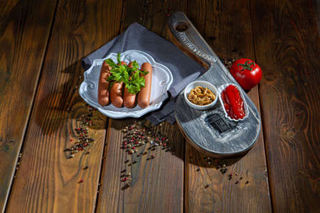 Sausage and vegetables on an old wooden deskの写真素材