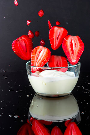 Strawberries fall into cream with splashesの素材