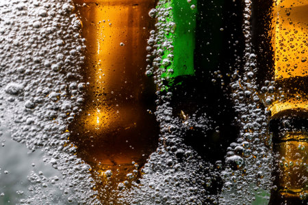 Bottles of beer with foam, bubbles and dropsの素材