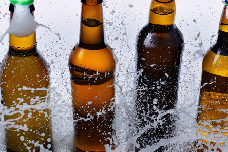 Bottles of beer with foam, bubbles and dropsの素材