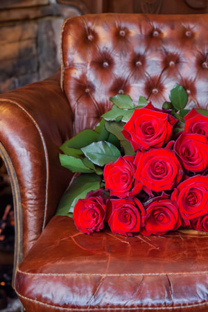 Bouquet of red roses on an old leather armchairの素材