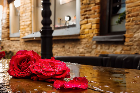 Roses lying on the paved old street in the puddle after the rainの素材