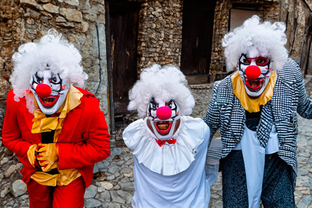 Group of clowns on the old street in a small townの素材
