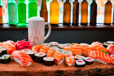 Sushi and beer on an old wooden bar near the windowの素材