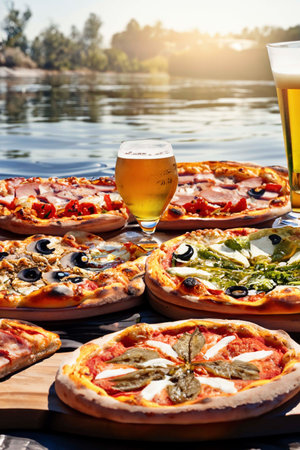 Several pizzas and beer on the surface of the waterの素材