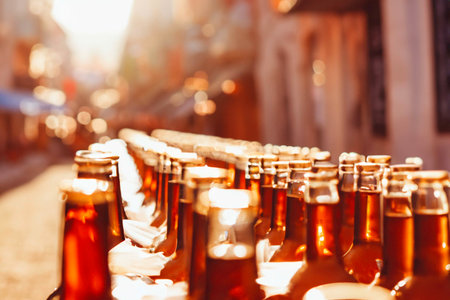 Bottles and glasses of beer in an old small townの素材