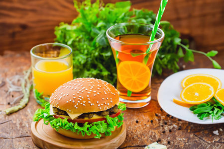 Burger with ham and a glass of juiceの素材