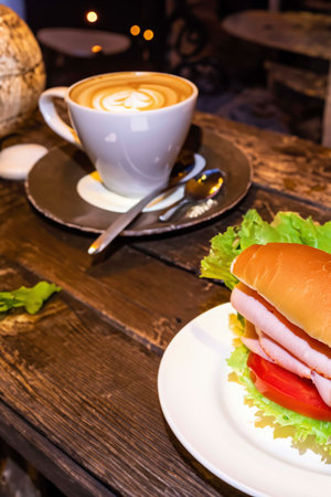 Burger on a table in a street cafeの素材