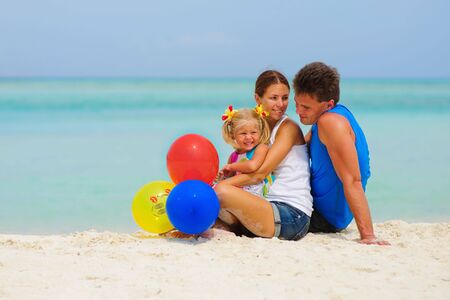 happy family have a party with balloons on tropical beachの写真素材