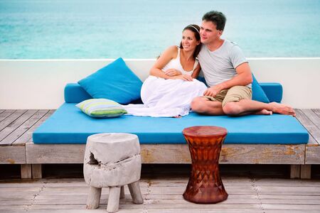 happy young beautiful couple siting in beach cafe and relaxingの写真素材