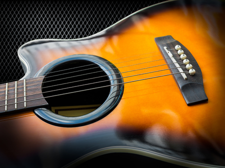 Acoustic guitar on black metal backgroundの写真素材
