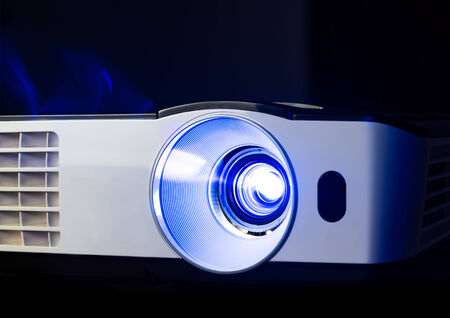 Closeup of projector for presentation in blue light toneの写真素材