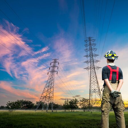 Engineer safety survey of the electricity pylon on sunrise time