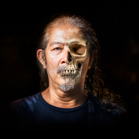 Fade off from skin to skull on the old human faceの写真素材