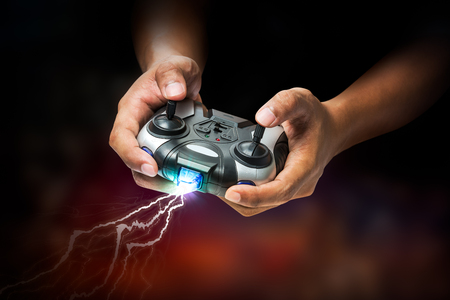 Wireless transmitter remote controller in hand for playing computer game or toy controlの写真素材