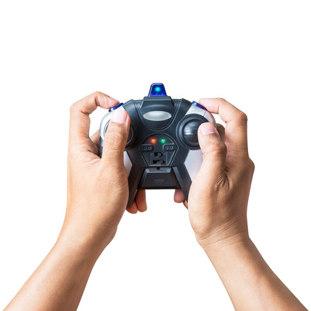 Wireless joystick controller in hand for playing game or toy control isolated on white background...