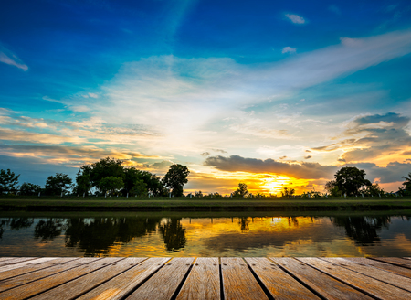 Wooden walkway at riverside on beautiful sunset backgroundの写真素材