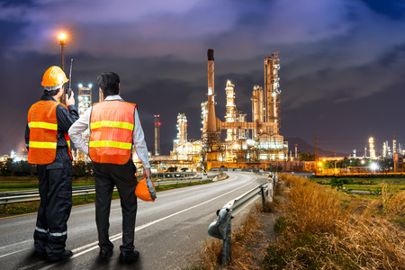 Engineer team in uniform are safety survey of the oil refiner industry