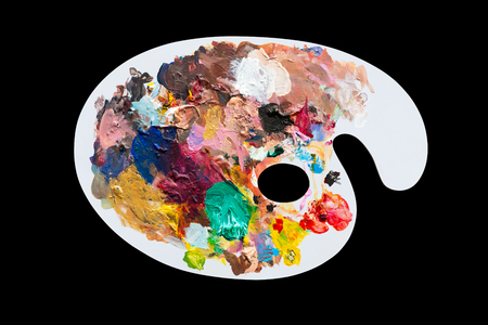 White wooden palette with oil paint color isolated on black backgroundの写真素材