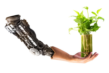 Robot hand hold on houseplant in the bamboo vase isolated on white backgroundの写真素材