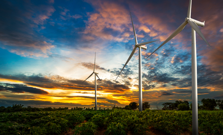 Wind turbine site at the agriculture land on sunset backgroundの写真素材