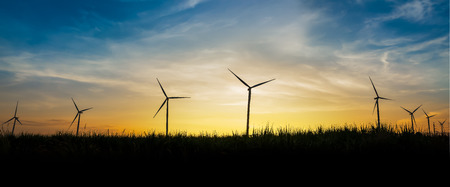Silhouette of wind turbine site on sunset background