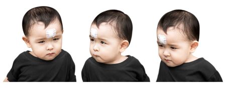 Little boy have a injury on forehead isolated on white backgroundの写真素材