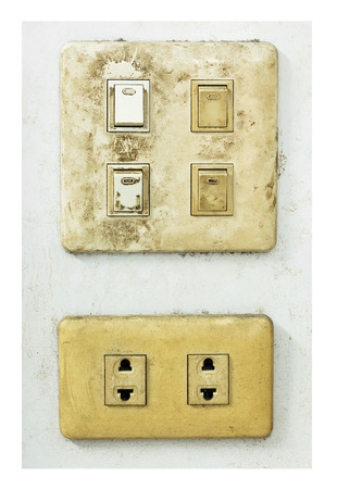 Grunge and dirty outdated electrical wall plug with switch