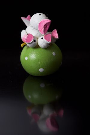 Small easter decoration on black background with reflection Small easter decoration on black background with reflection