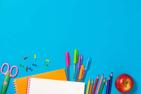 The concept of going back to school. Colorful school supplies, notebooks, pencils, pens, paper...