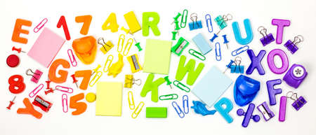 School supplies are laid out in the form of a rainbow. Light background. Arts and crafts for...