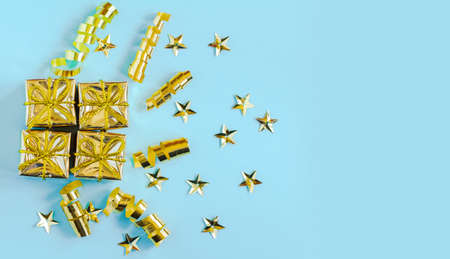 Set of gold gift boxes, streamers and stars on a blue background. Holiday greeting card. Christmas, New year, birthdayの写真素材