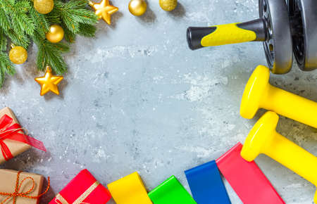 Exercise, fitness concepts happy Christmas and New year. Yellow dumbbells, fitness bands, a...