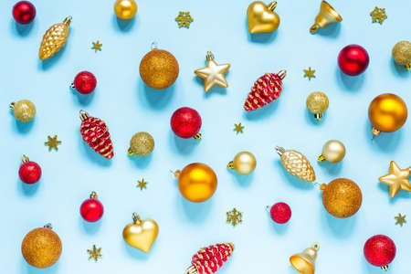 Background with Christmas toys, red and gold on a blue background. Balloons, stars, bells, snowflakes and cones. New year, Christmasの写真素材