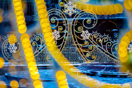 New Years and Christmas. Christmas street decoration in the form of yellow patterns and snowflakesの写真素材