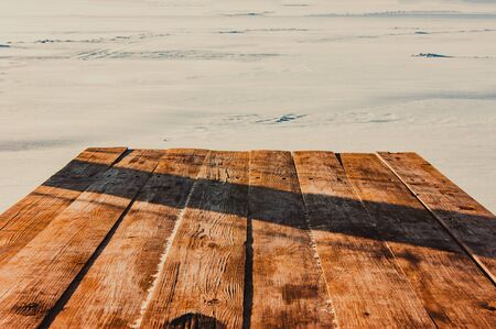 Countertop overlooking the winter lake. Winter gazebo on the shore of a frozen lake.の写真素材