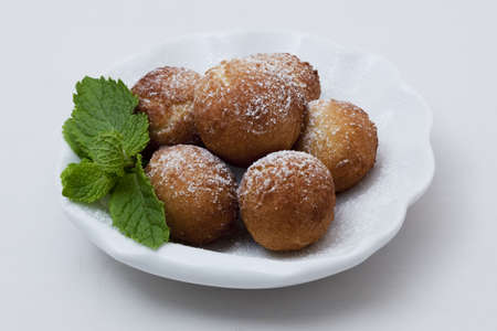 The six curd donuts on a white plateの写真素材